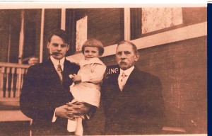 Gerard W.(G.W.) Helbling holding his son Edgar and with his father, Francis X. Helbling, on the right. c1908