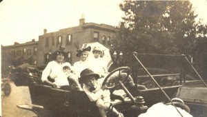 Anna May (Beerbower) Helbling holding 16 mo.old Viola Gertrude Helbling, Anna May's mother to her right is Anna Missouri (Springsteen) Beerbower, 3 y/o Anna May Helbling (called May), and 6 y/o Edgar Bradley Helbling in front by steering wheel. Flag Day, June 1914.