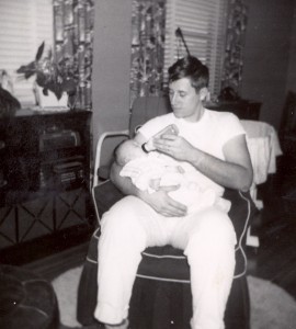 1954- Edward A. McMurray, Jr., feeding daughter.