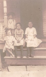 The Cooper Children. Irving Cooper standing in Indian costume. Girls, from left: Loretta, Rose, and Ann Cooper, c1913.