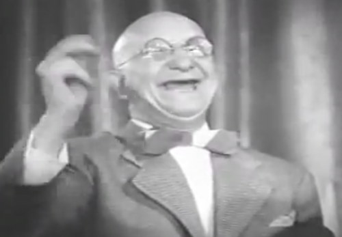 Buster Brodie as the smiling piano player in "A Groovie Movie" a 1944 short.