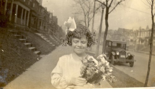 Mary Theresa Helbling In The Procession, April, 1932. Note big hair bow and old car in background.