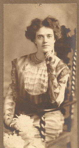 Lynette Payne, December 1909, wearing a purple and lavender silk dress.