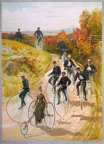 Bicycling ca1887- big wheels and a ladiy with a long skirt. Library of Congress via Wikipedia, public domain.