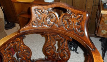 Likely John Broida's chair, brought to US from Eastern Europe; detail of carved backrest.