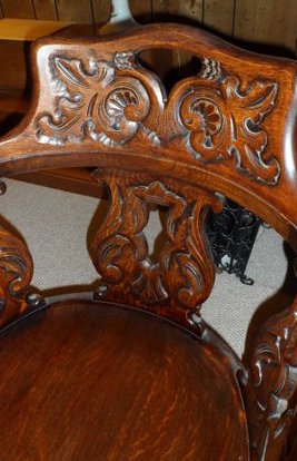 Likely John Broida's chair, brought to US from Eastern Europe; close-up of carved backrest.